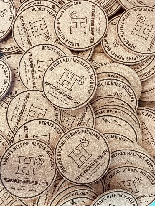 Custom engraved round coasters made by Adam’s Gear Solutions for a local business