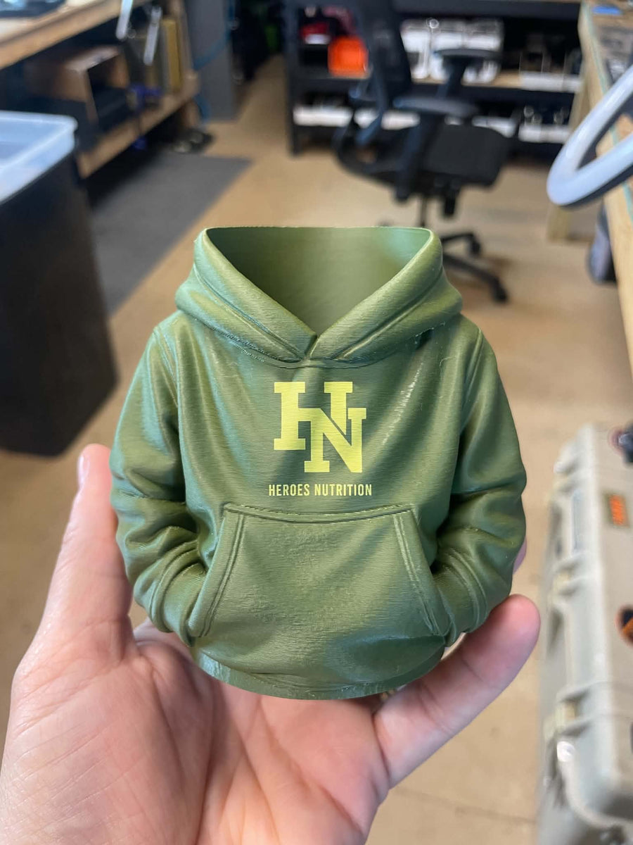 Green 3D printed hoodie-shaped holder with Heroes Nutrition branding