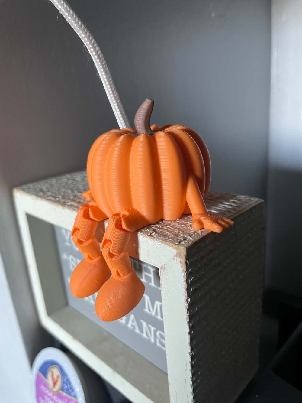Orange 3D printed pumpkin with articulated legs